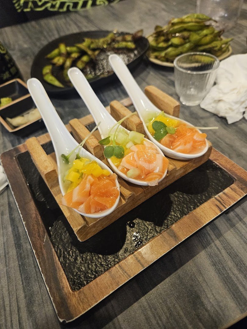 A busy sushi house with counter seating.